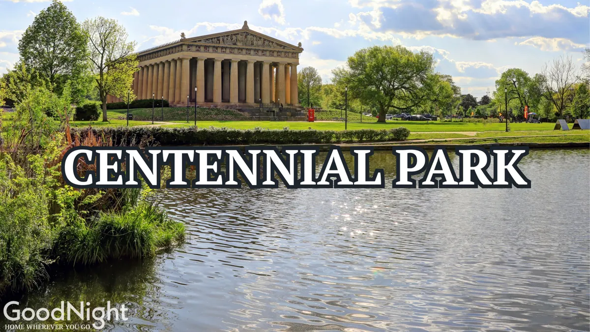 A grand exterior view of the Parthenon-like structure nestled beside calm water, surrounded by lush greenery and bathed in serene sunset light. People are seen walking and picnicking in the expansive park area, evoking a sense of relaxation and family-friendly leisure.
